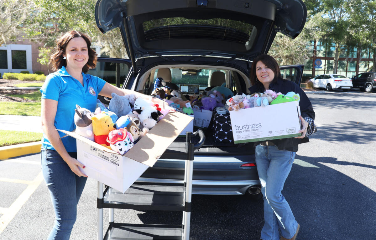 Employees of the Lake County Clerk's Office load donated stuffed animals for delivery to the Haven of Lake and Sumter Counties.