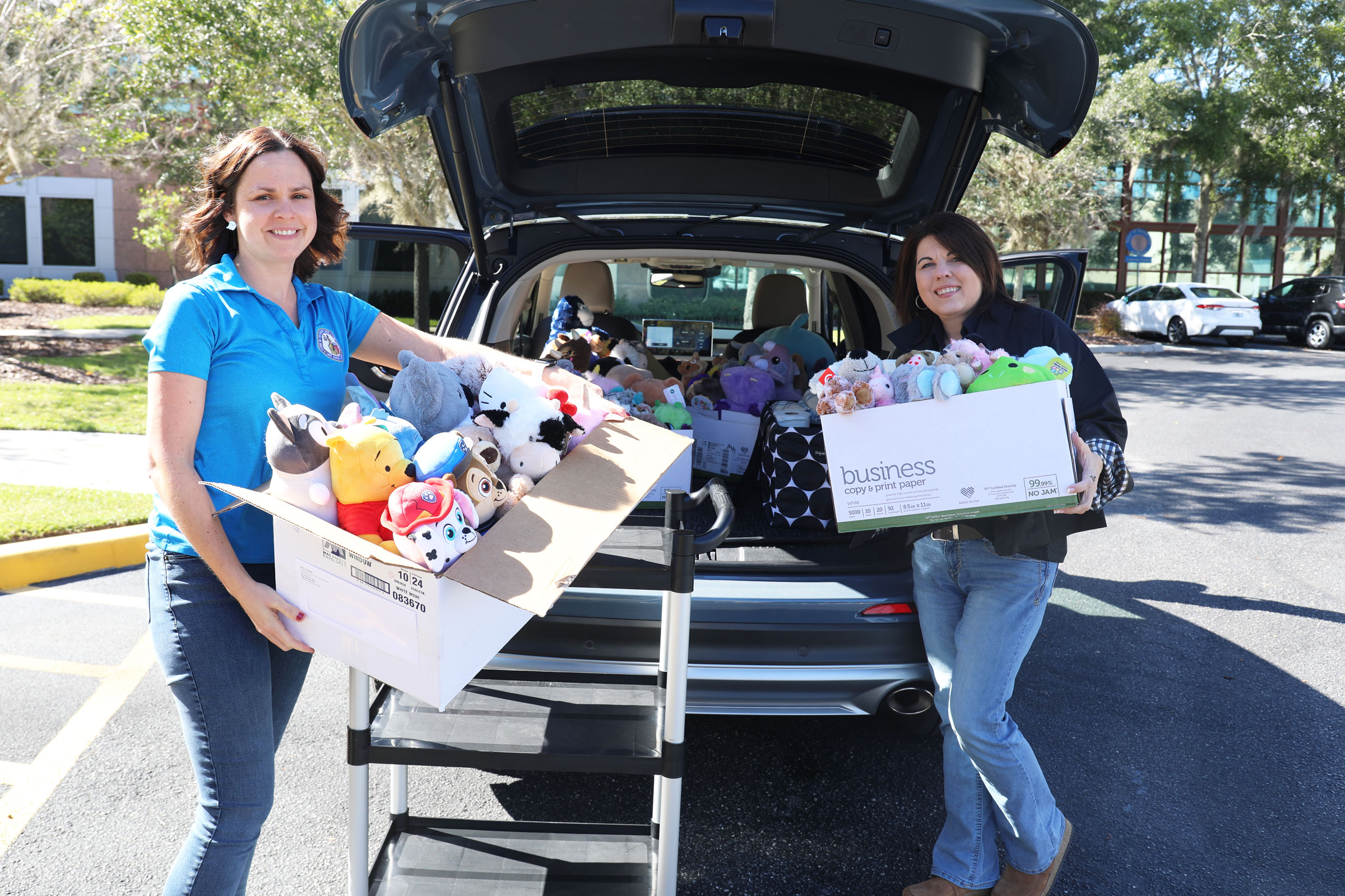 Employees of the Lake County Clerk's Office load donated stuffed animals for delivery to the Haven of Lake and Sumter Counties.