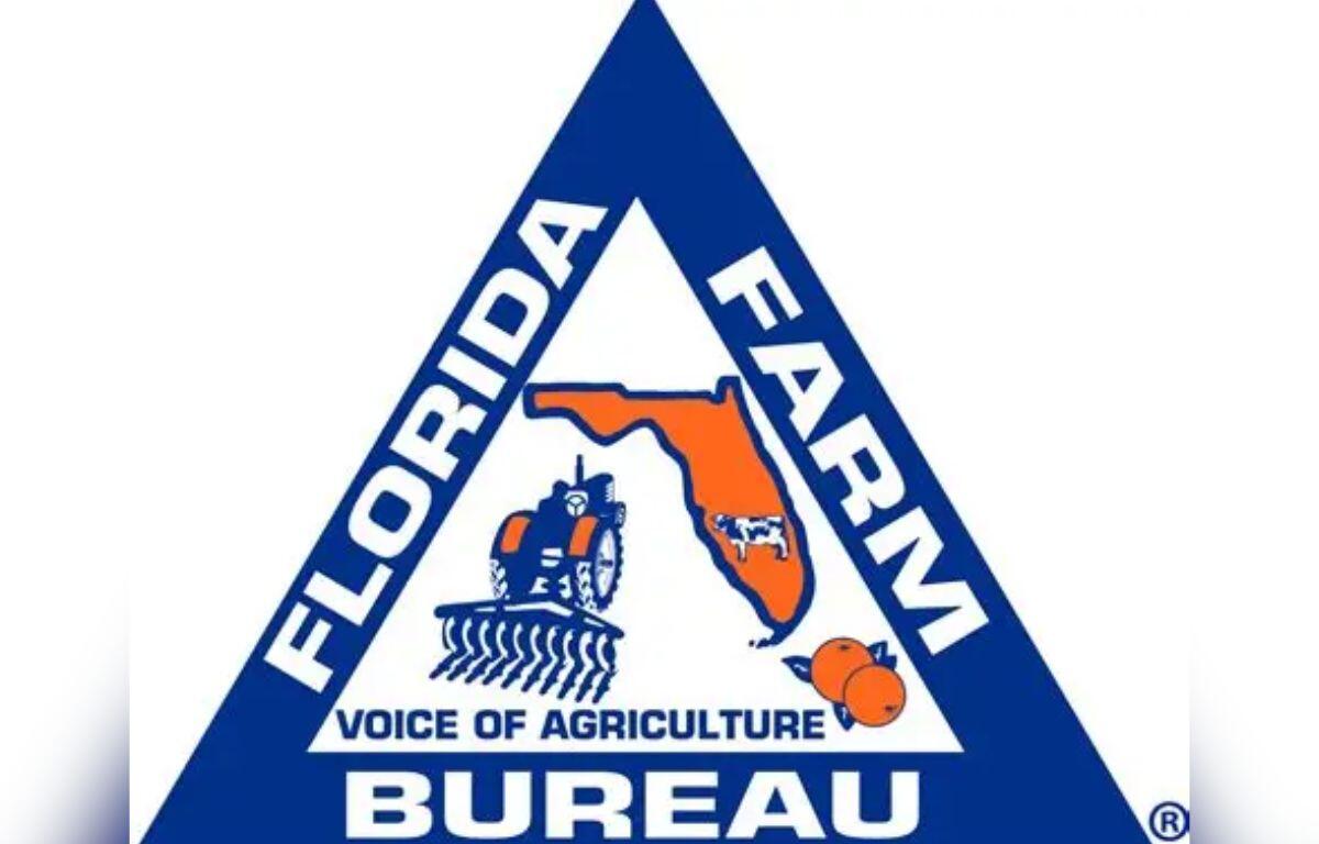 A blue triangle, with white lettering and on the inside multiple symbols, blue, white and orange in color.