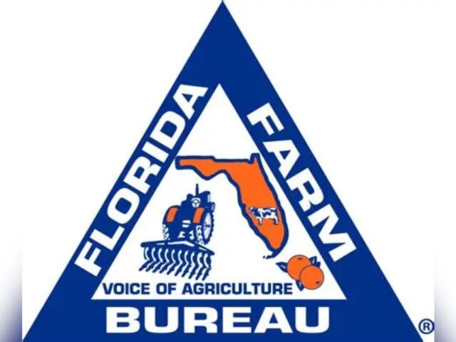 A blue triangle, with white lettering and on the inside multiple symbols, blue, white and orange in color.