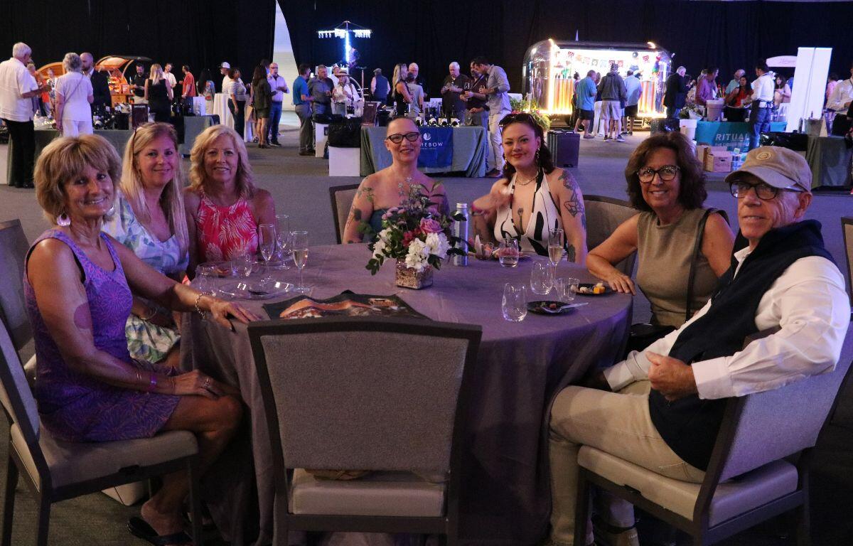 A group of people enjoy food samples together.