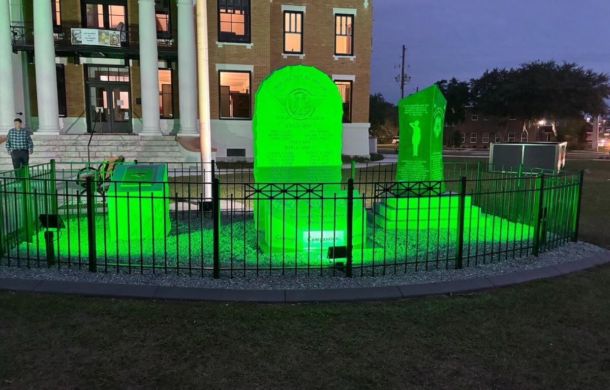 The Old Courthouse Heritage Museum Veterans Memorial lit up in green
