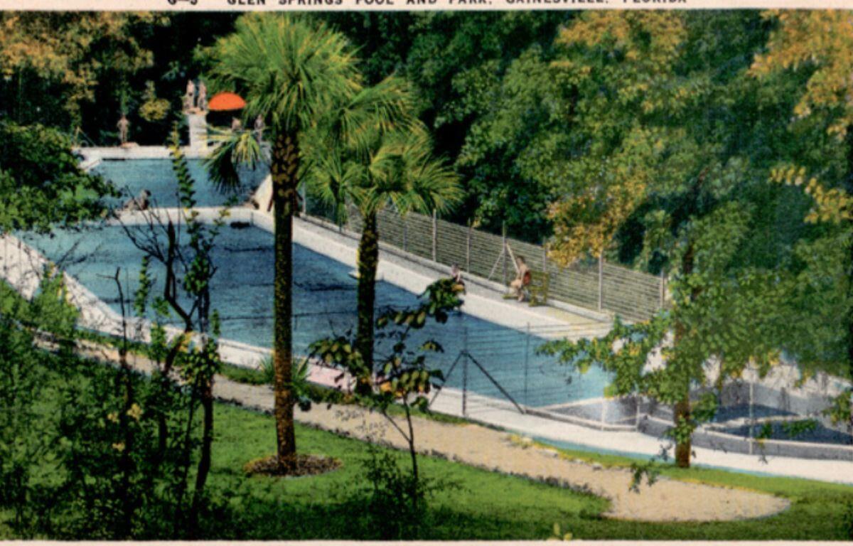 Color postcard-style image of Glen Springs showing the bright blue spring pool, surrounding greenery, and walkways leading toward the water.