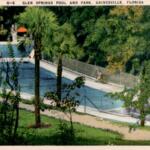 Color postcard-style image of Glen Springs showing the bright blue spring pool, surrounding greenery, and walkways leading toward the water.
