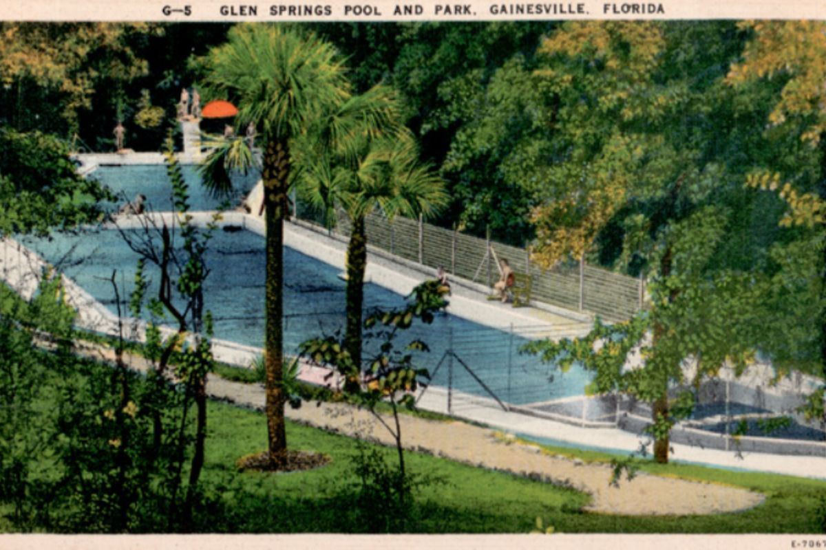Color postcard-style image of Glen Springs showing the bright blue spring pool, surrounding greenery, and walkways leading toward the water.