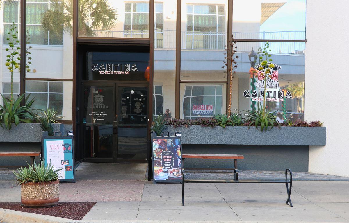 The front of a restaurant has reflective windows and logos that read, "Cantina Tex-Mex & Tequilla Bar."