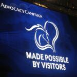 White lettering on a blue background, with the image of a horse's head and a heart, with white lettering underneath.