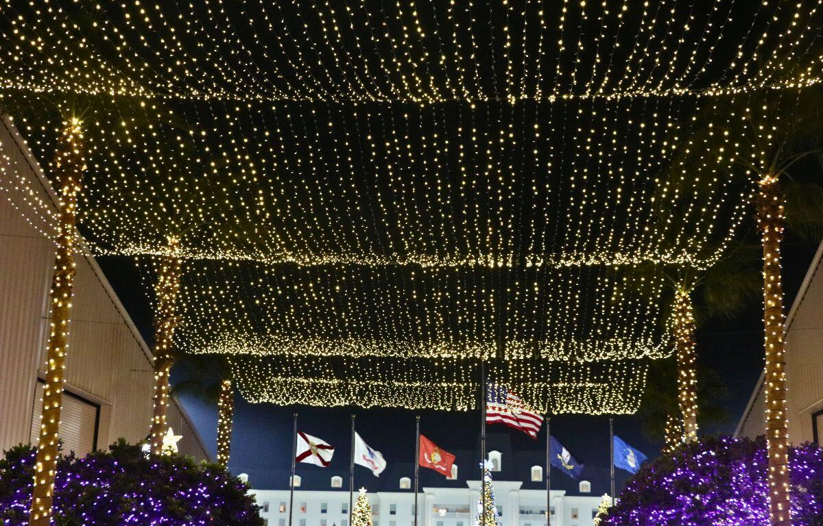 A illuminated ceiling of Christmas lights hanging overhead.
