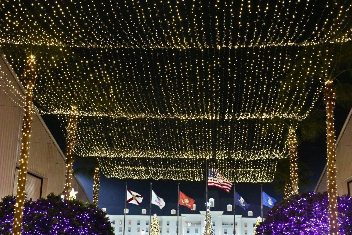 A illuminated ceiling of Christmas lights hanging overhead.