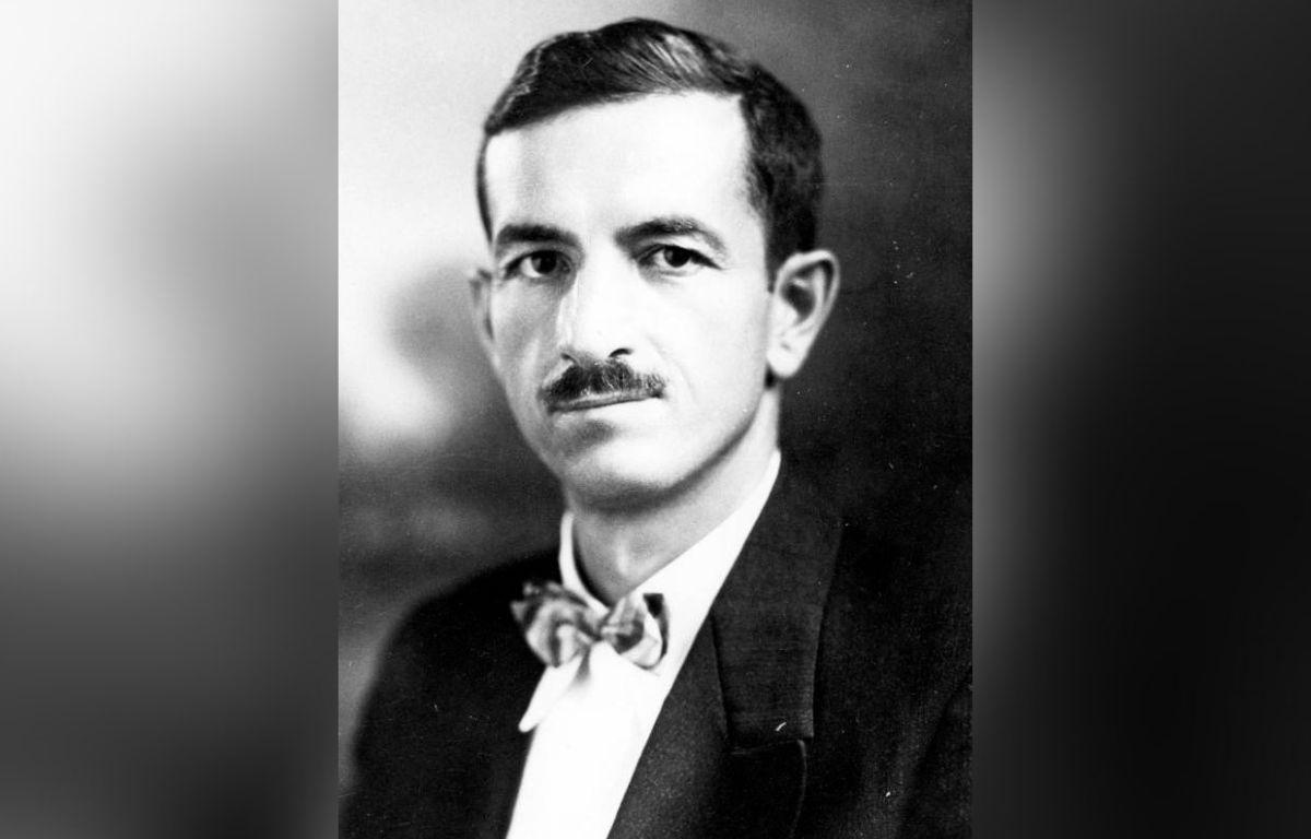 A black-and-white portrait photograph of a man in a suit.