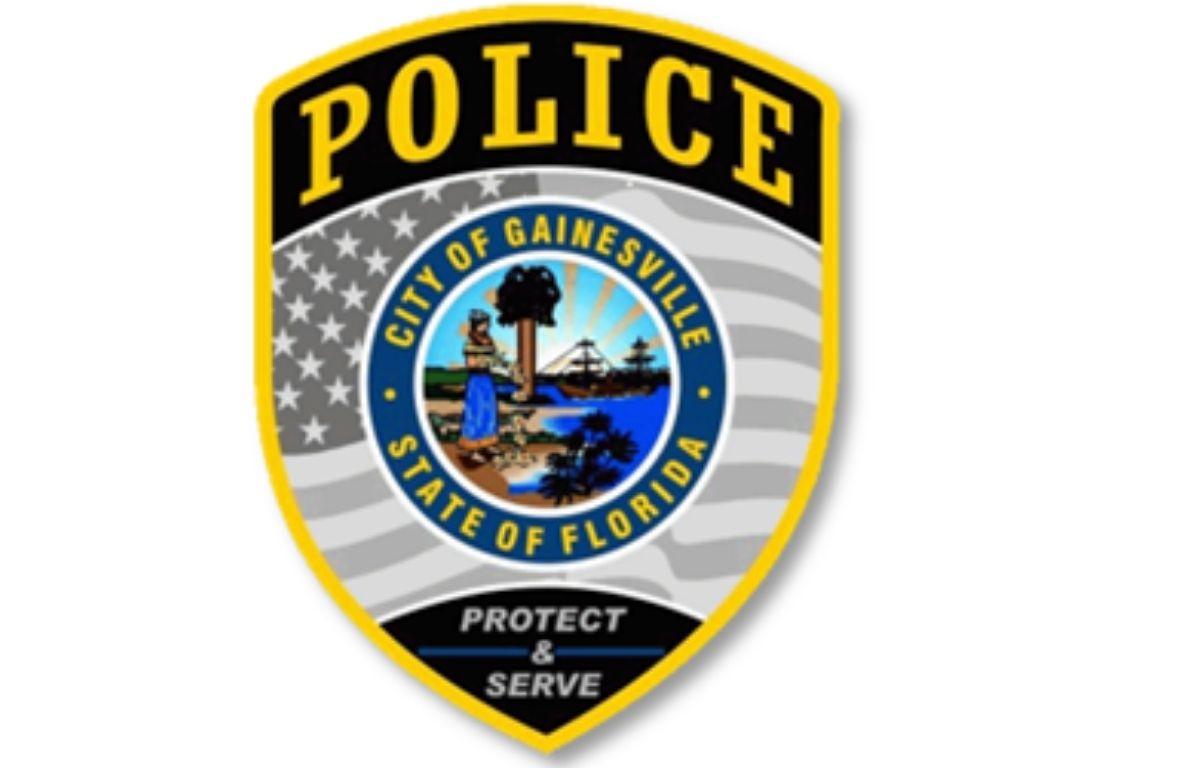 A badge with multiple colors, an insignia with an image and writing on it, and an American flag and writing within the body of the badge