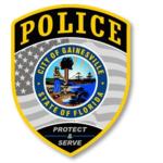 A badge with multiple colors, an insignia with an image and writing on it, and an American flag and writing within the body of the badge