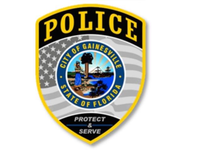 A badge with multiple colors, an insignia with an image and writing on it, and an American flag and writing within the body of the badge