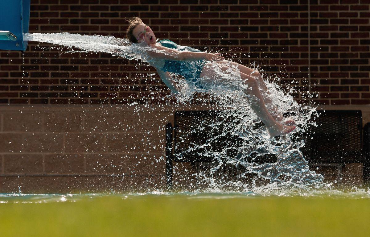 a girl coming off a waterslide