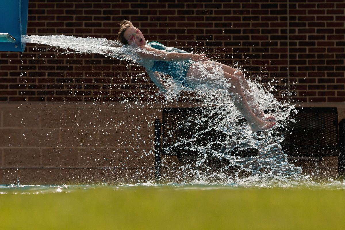 a girl coming off a waterslide