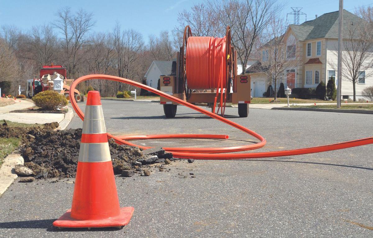 a crew works on installing fiber optic cable