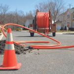 a crew works on installing fiber optic cable