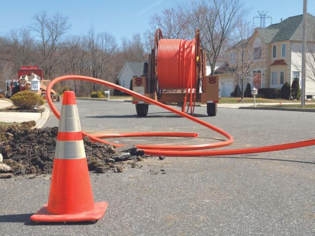a crew works on installing fiber optic cable
