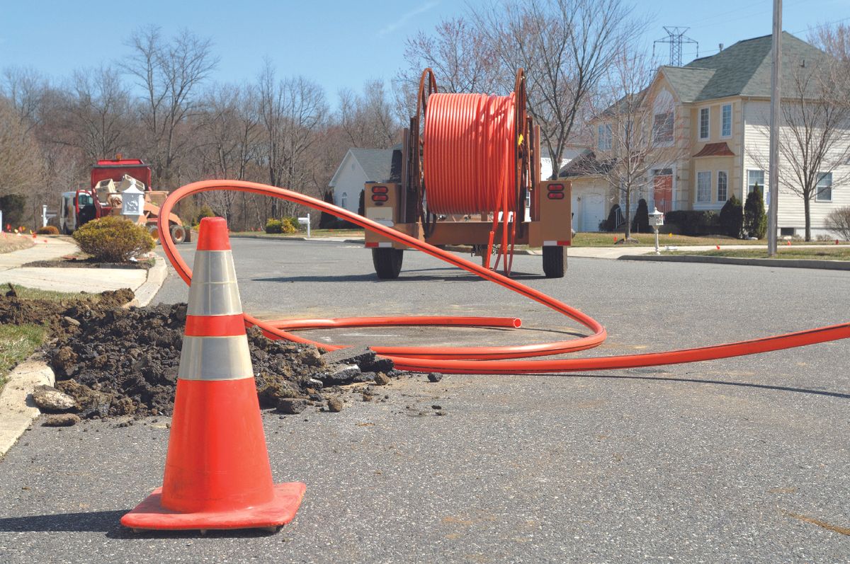 a crew works on installing fiber optic cable