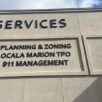 Beige facade of building with brown lettering.