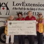 Orange Blossom Gardens Lions Club members present a donation check to LovExtension