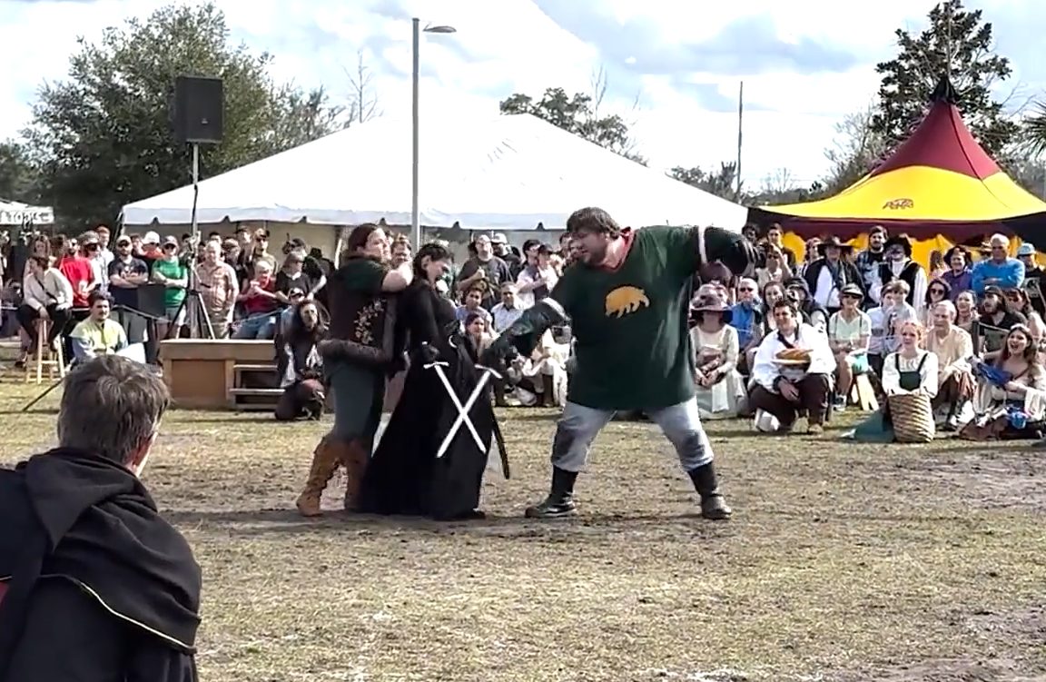 performers swordfight at hoggetowne medieval faire in gainesville