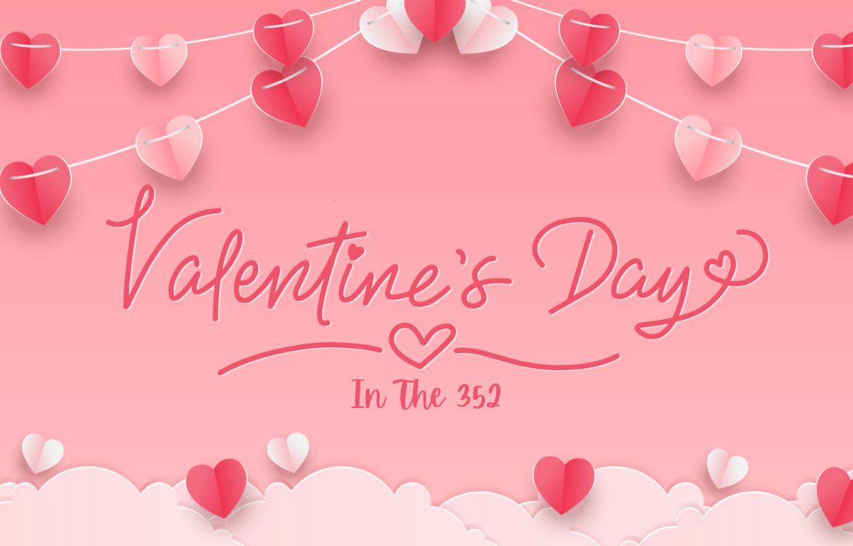 A pink background decorated with a garland of red and pink hearts with text that reads, "Valentine's Day in the 352."
