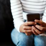 a Black woman using her smartphone