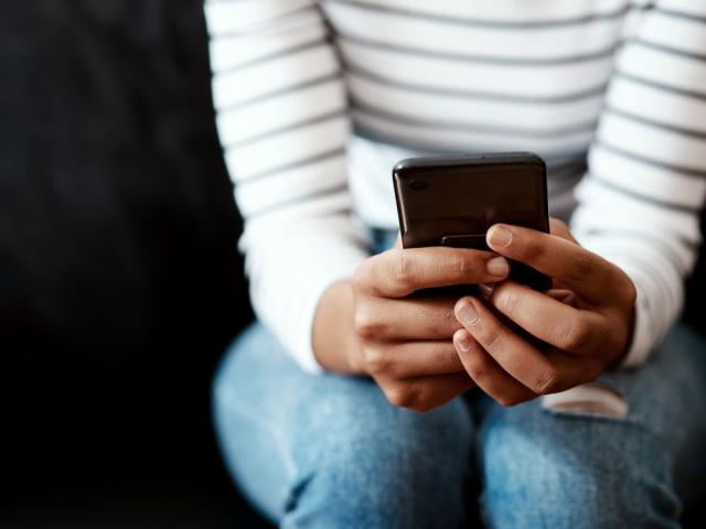 a Black woman using her smartphone