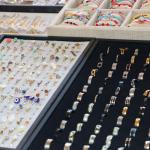 Jewelry is displayed in boxes with velvet linings.