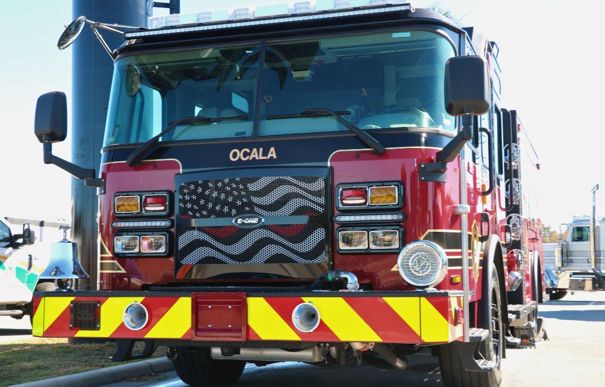 A first responder truck is parked in a lot with other first responders and a variety of other semi-trucks.