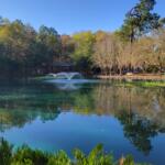 A man-made lake with a foundation and a gazebo in the background.