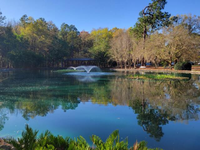 A man-made lake with a foundation and a gazebo in the background.