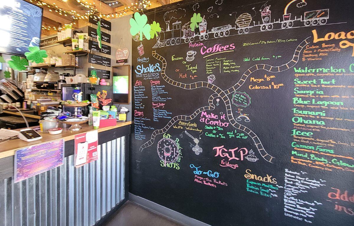 A menu chalkboard wall with counter.