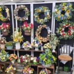 Display of decorative items arranged vertically on a rack or stand.