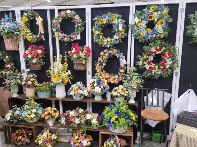 Display of decorative items arranged vertically on a rack or stand.