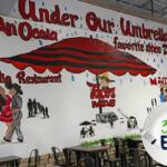 A mural with a red umbrella that reads, "Under One Umbrella - An Ocala favorite since 2008"