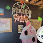 A sign that says, "The Station Nutrition" against a black wall.