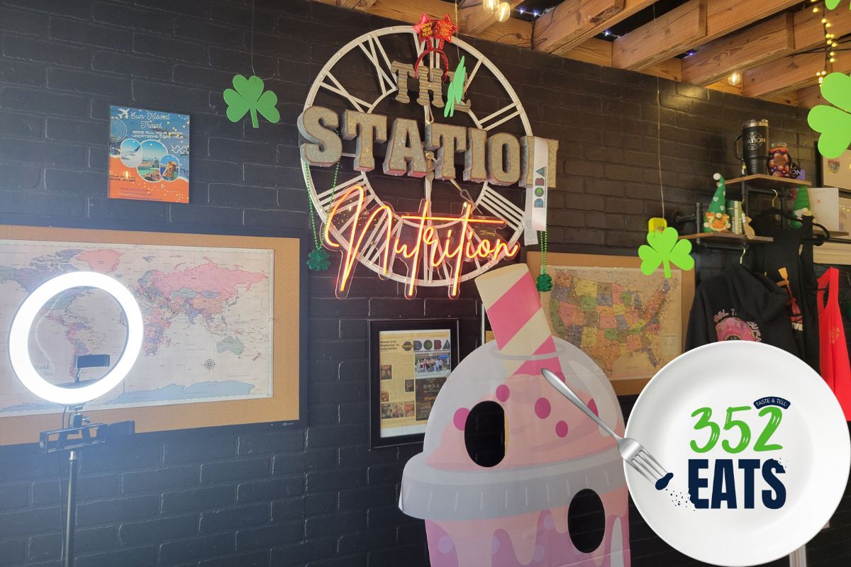 A sign that says, "The Station Nutrition" against a black wall.