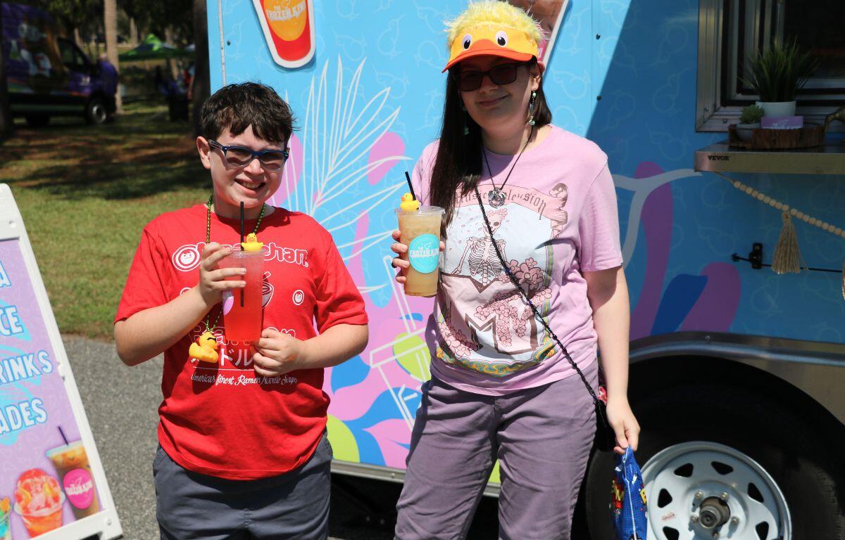 Guests at an event get drinks of a food truck.