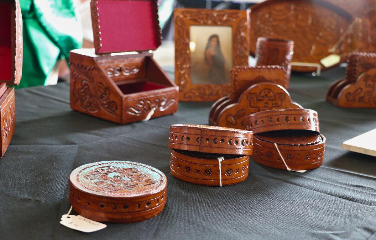 Wooden items are scattered on a table with a black tablecloth.