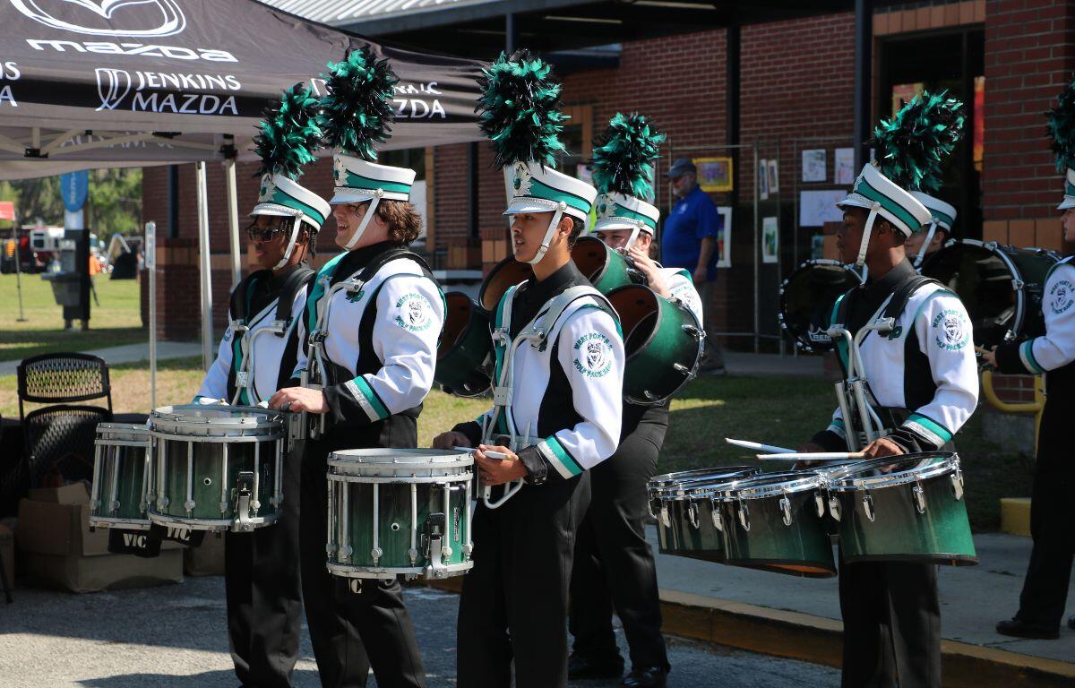 The West Port drumline performs for a crowd of guests.