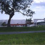 A colored photo of a white building labeled "Golden Hills Theatre" behind a tree.