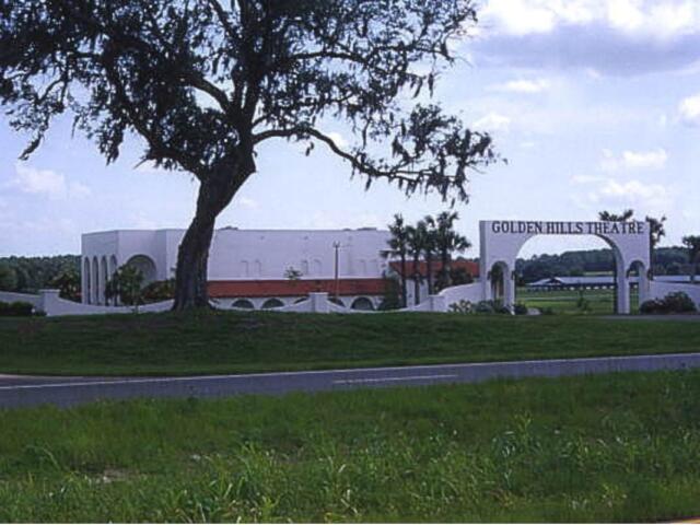 A colored photo of a white building labeled "Golden Hills Theatre" behind a tree.