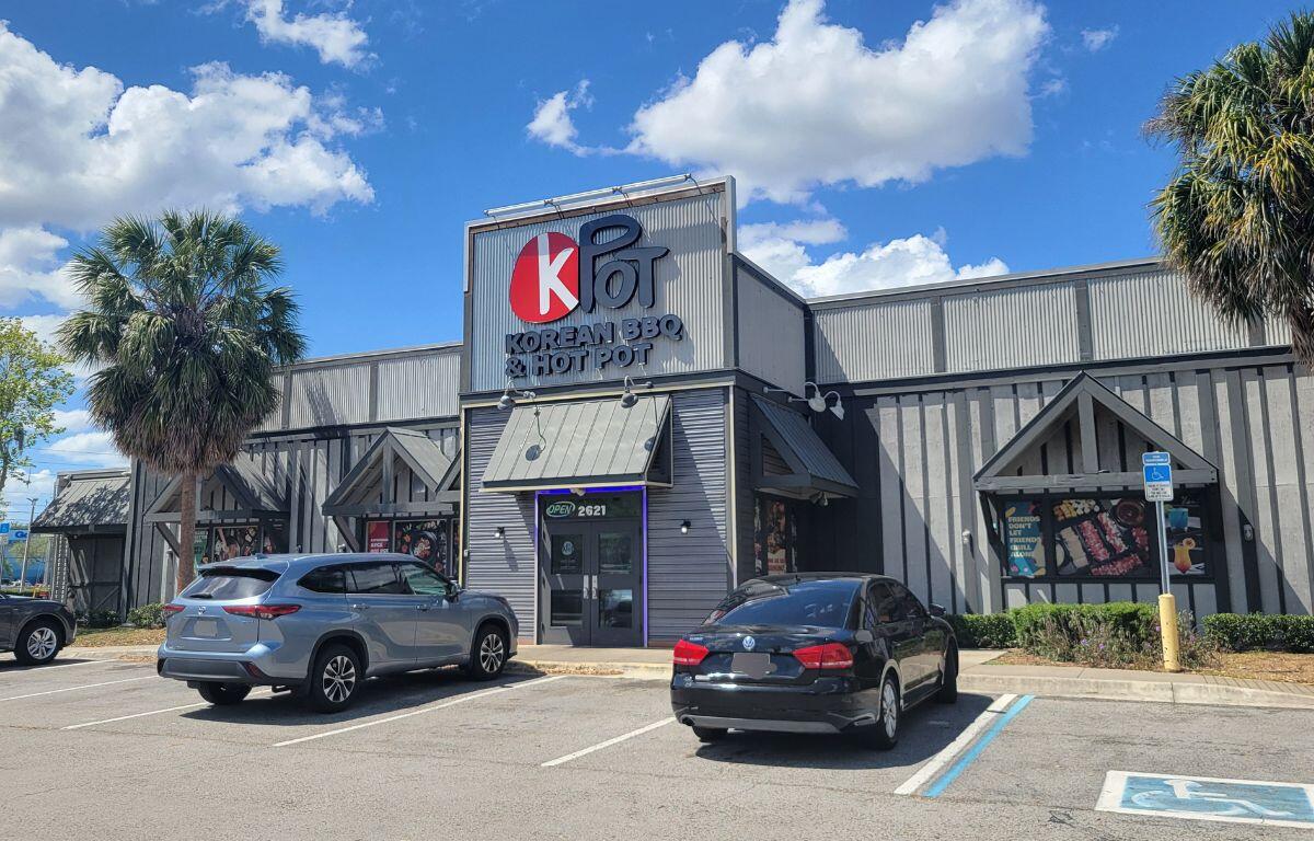 A gray storefront for KPOT Korean BBQ and Hot Pot.