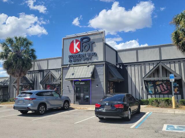 A gray storefront for KPOT Korean BBQ and Hot Pot.
