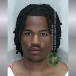 A colored image of an African American male with medium length hair in an orange and white striped jumpsuit,