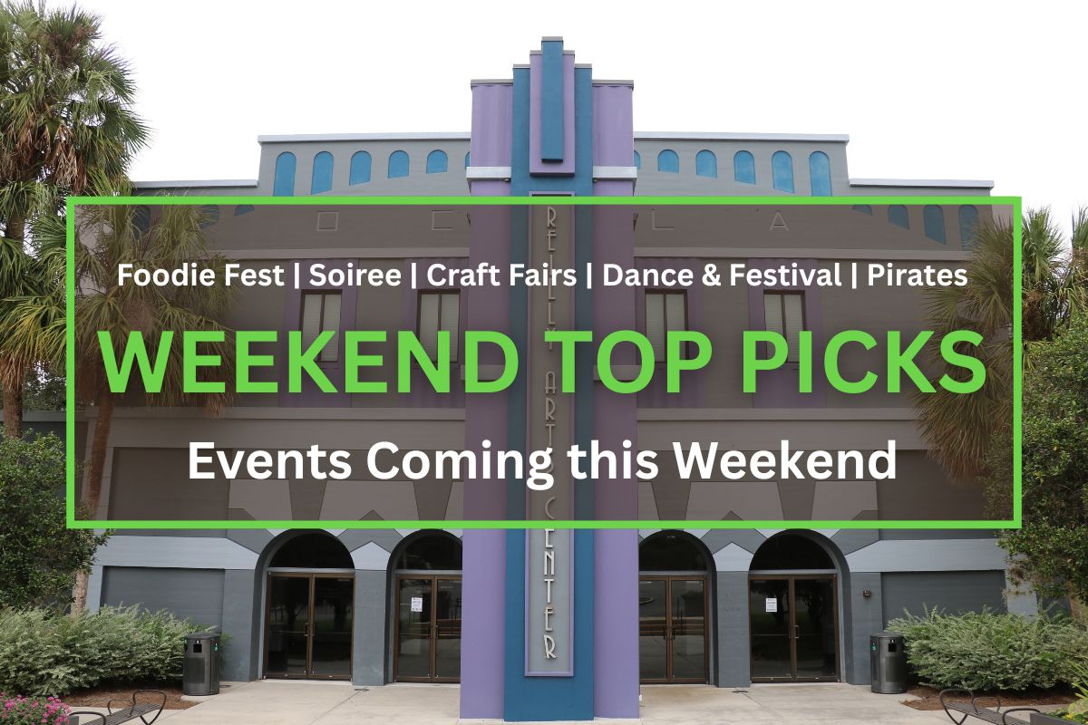 Front view of the Reilly Arts Center, featuring a gray and purple art deco facade with arched doorways and palm trees.