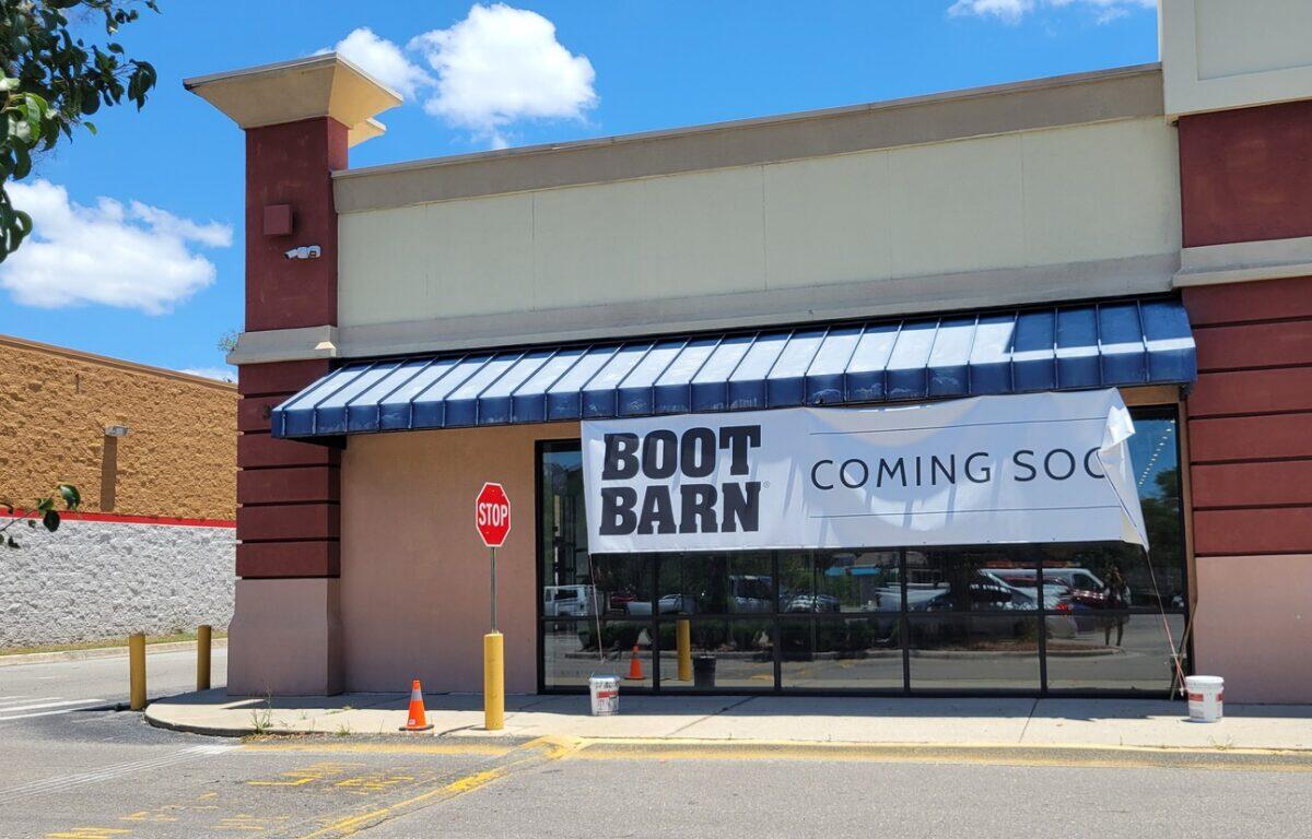 A storefront with a sign that reads "Boot Barn Coming Soon."