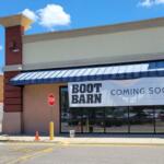 A storefront with a sign that reads "Boot Barn Coming Soon."